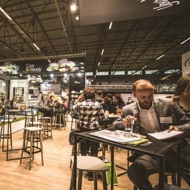 tables and people talking at trade show